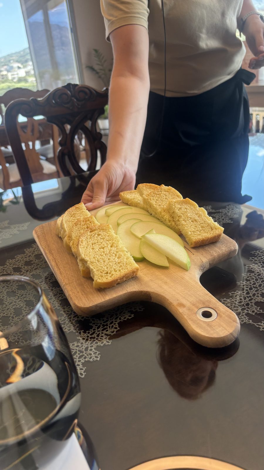 Board of toasted bread and green apple slices served at a private olive oil tasting in Crete